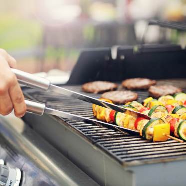 Skewers and hamburgers on barbecue