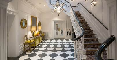 Manor house hall with chess tiles and splendid staircase