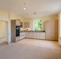 Open plan room with fitted kitchen