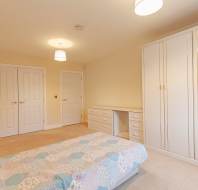 Bedroom with white wardrobes