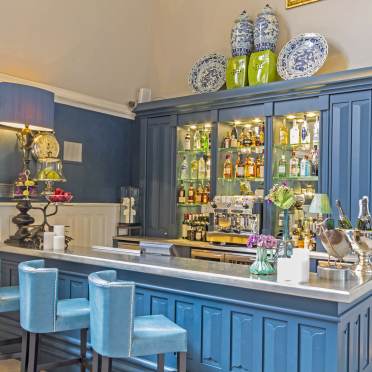 Blue-painted bar with plush stools and period fittings